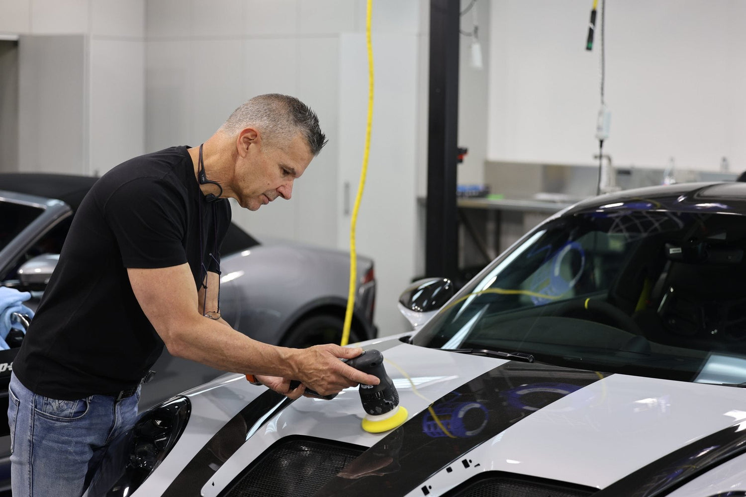 Paolo Recinella machine polishing a car in the Alpha Details studio, Heidelberg West Melbourne