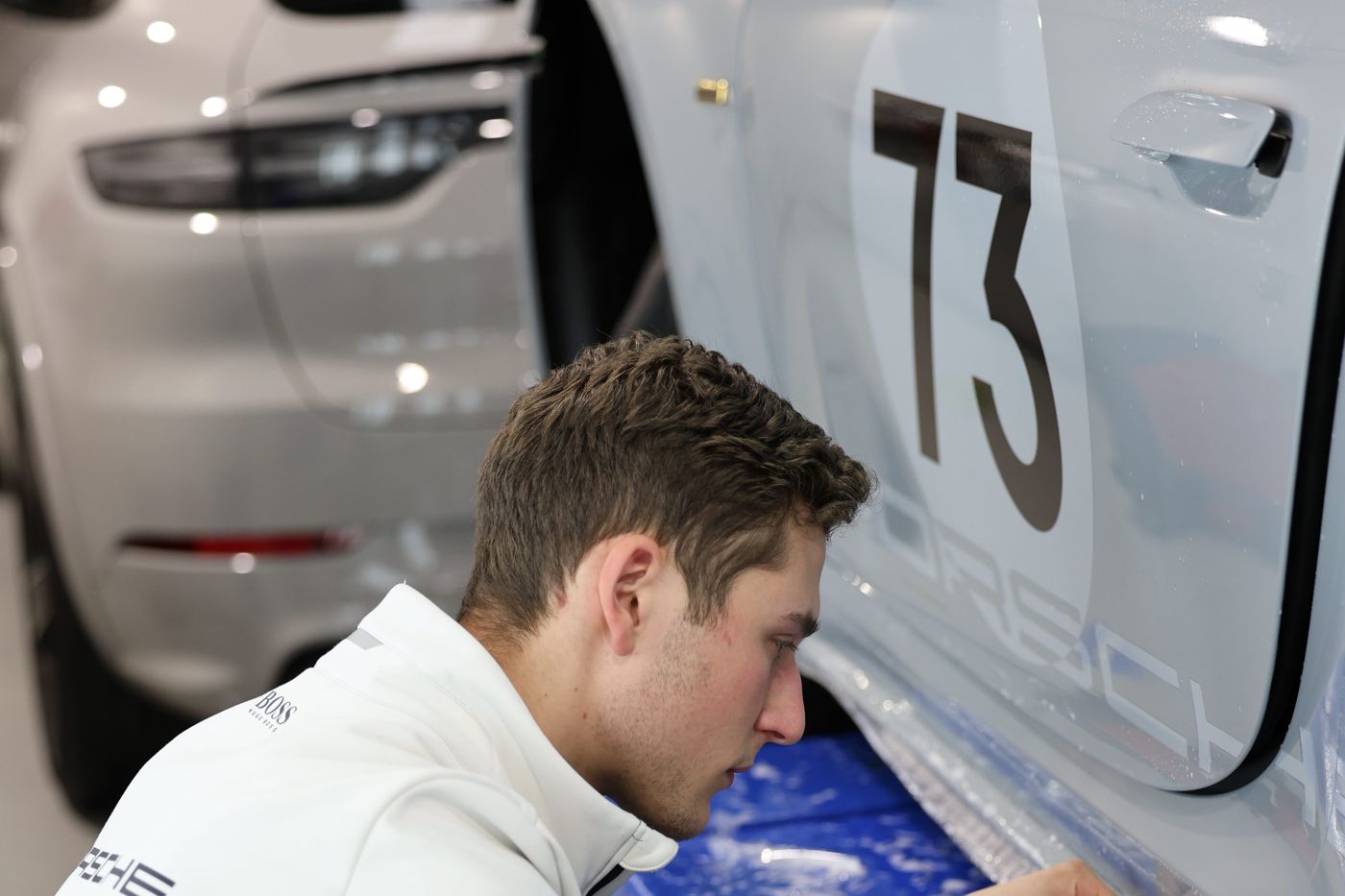 Alpha Details installing paint protection film by hand on a Porsche 911 race car