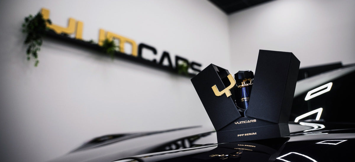 Yum Cars PPF Serum on a black bonnet in the Yum Cars studio