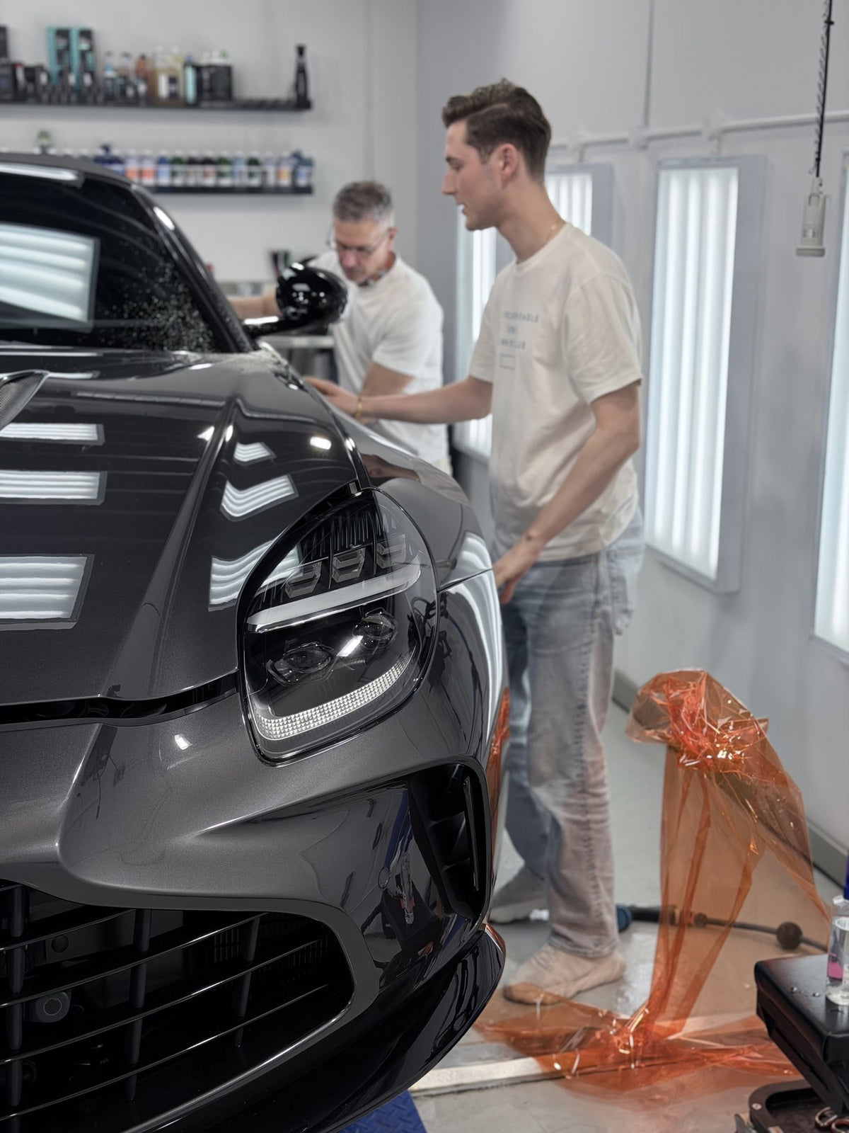 Paint protection film being installed on an Aston Martin