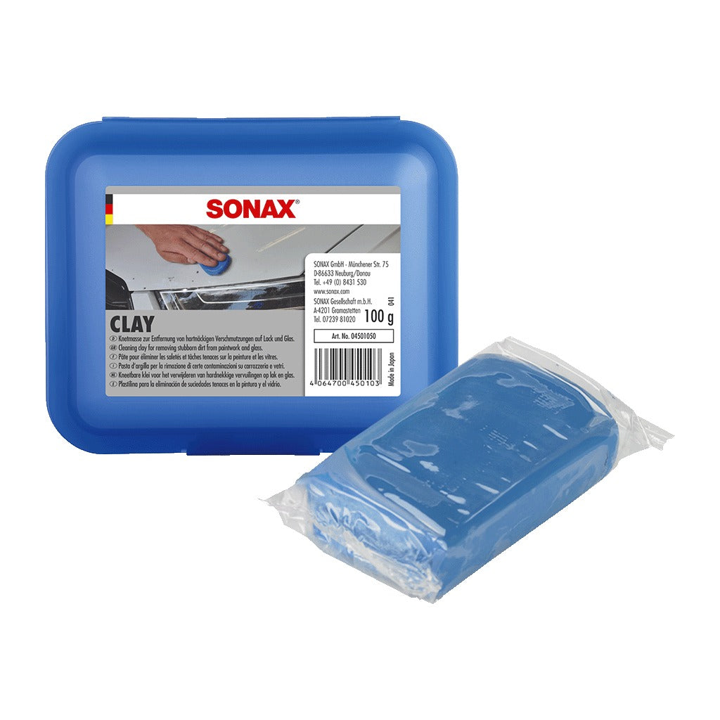 SONAX Clay 100g — blue hinged storage box with the 100 g clay bar in its wrapper, Art. No. 04501050, made in Japan