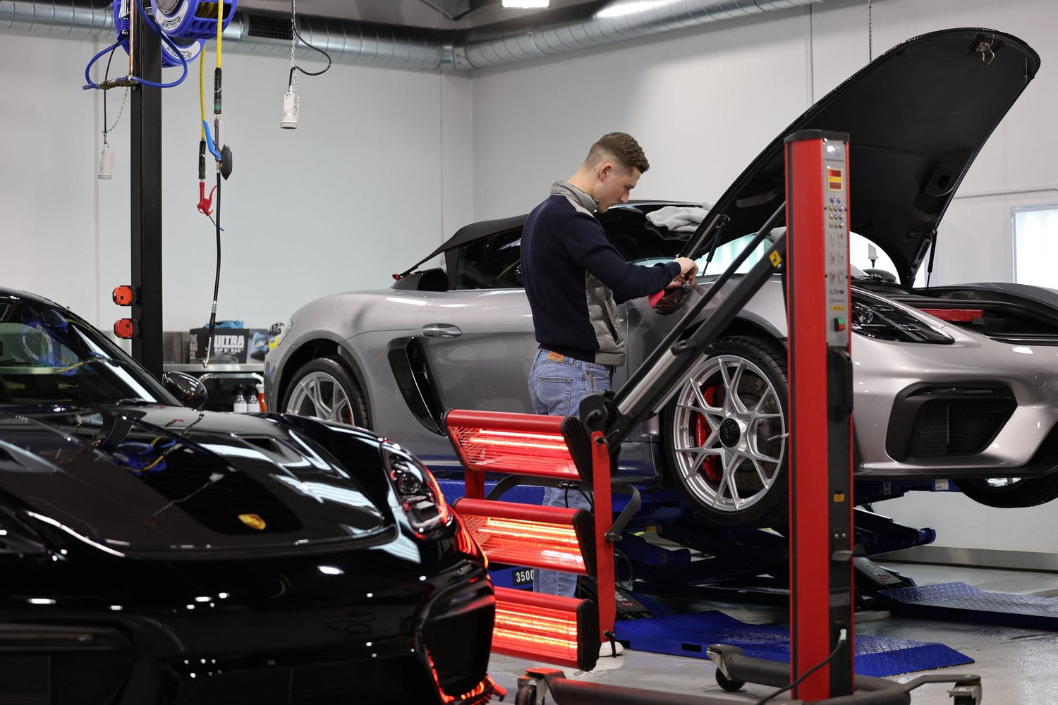 Porsche 718 on the hoist in the Alpha Details workshop, Heidelberg West Melbourne