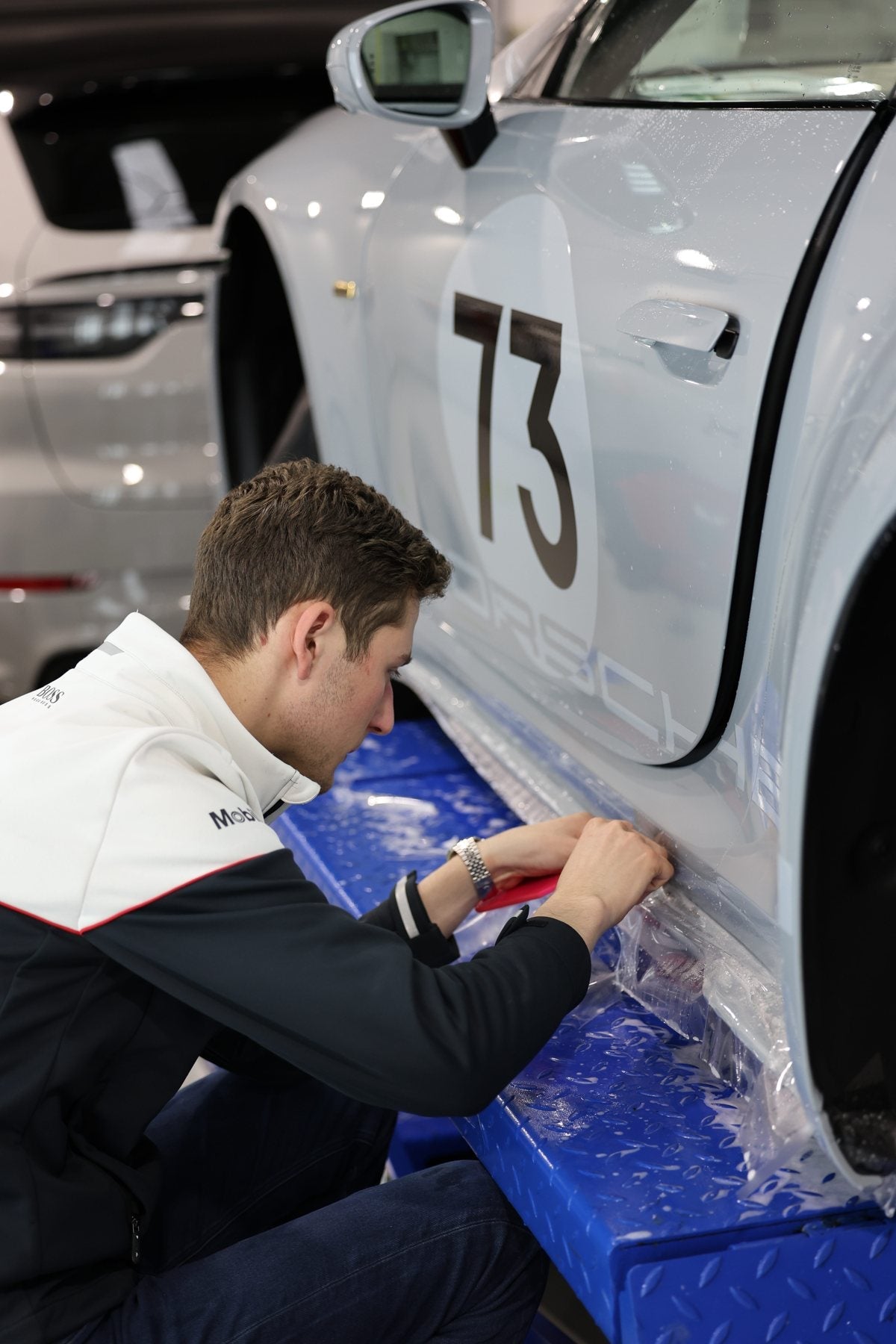 Paint protection film being installed on a Porsche at Alpha Details Melbourne