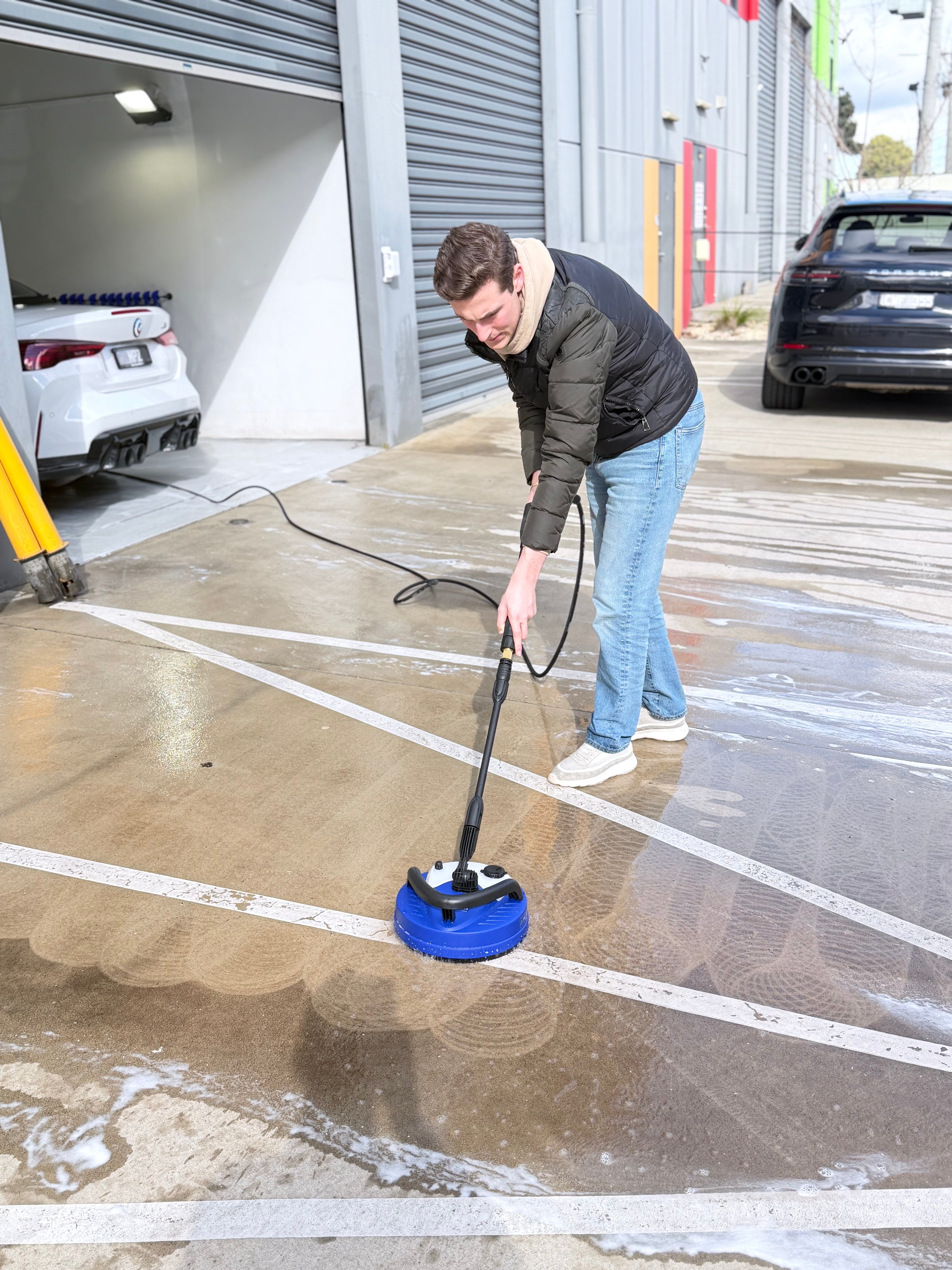 Annovi Reverberi patio cleaner attachment cleaning a concrete driveway at the Alpha Details Heidelberg West studio — rotary flat surface cleaner for pressure washers
