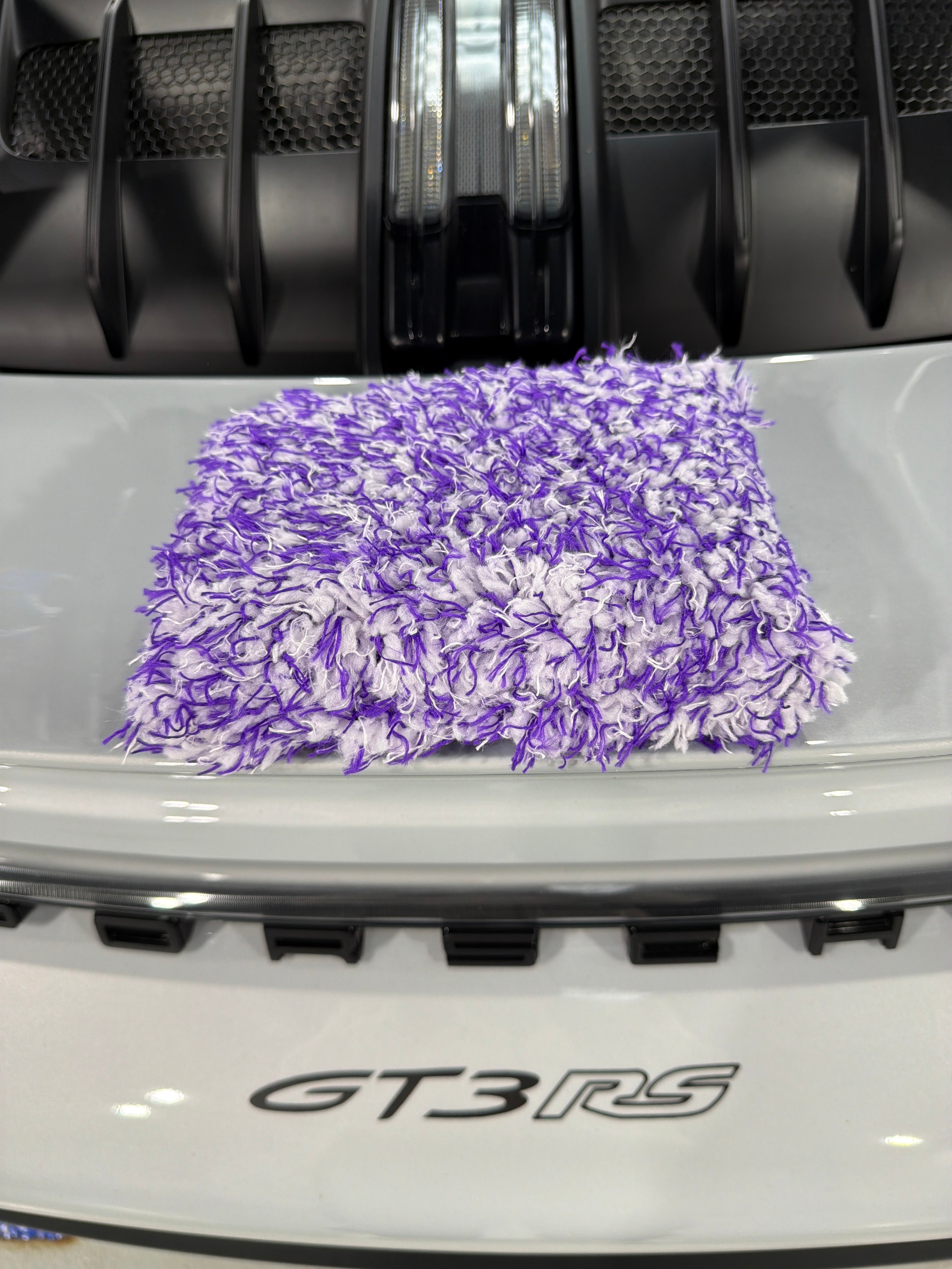 Aquatouch MUSCLES purple microfibre wash pad resting on a white Porsche GT3 RS — Alpha Details