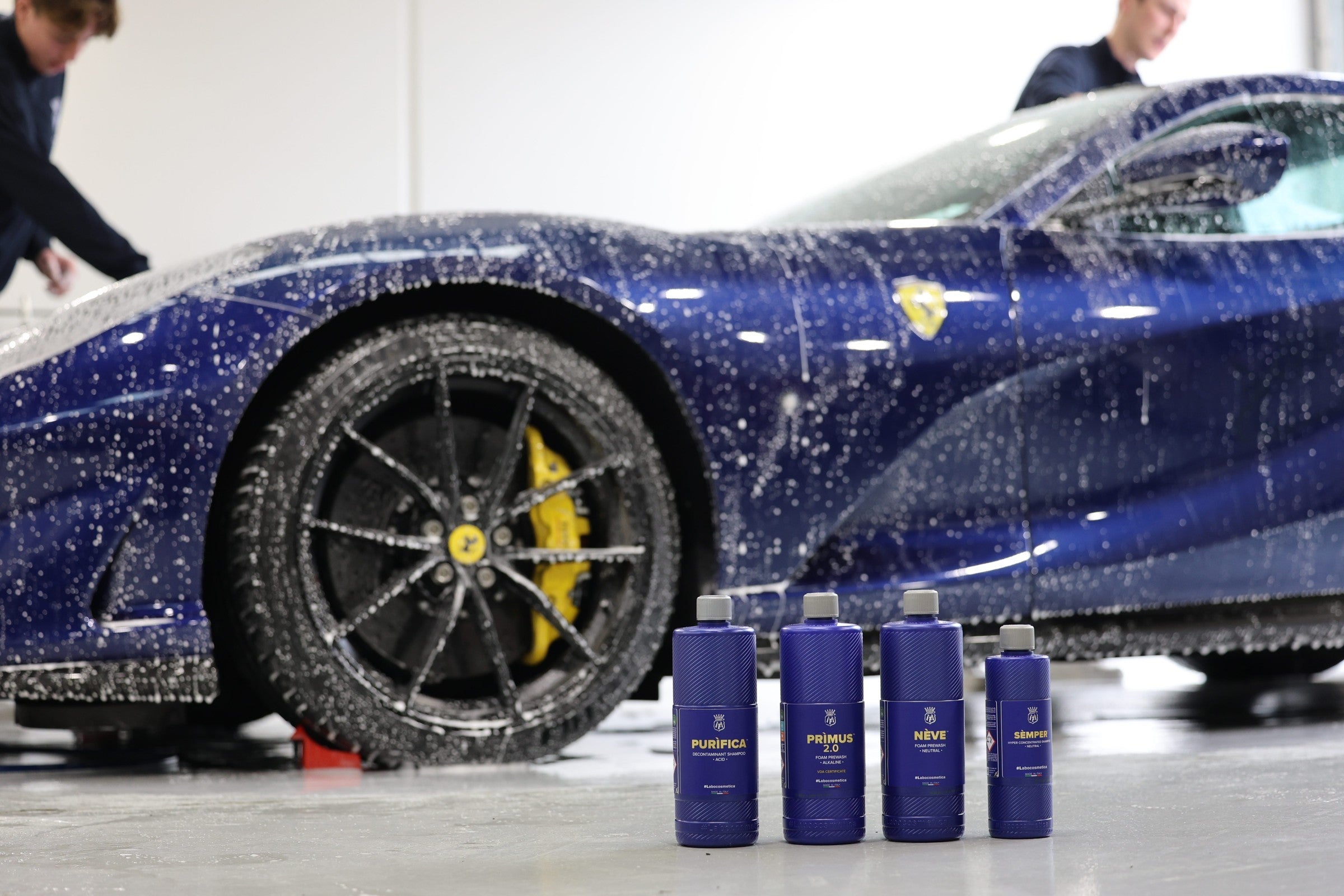 Labocosmetica 3pH Maintenance Wash System — Prìmus 2.0, Purìfica, Nève and Sèmper in front of a blue Ferrari under snow foam at the Alpha Details studio