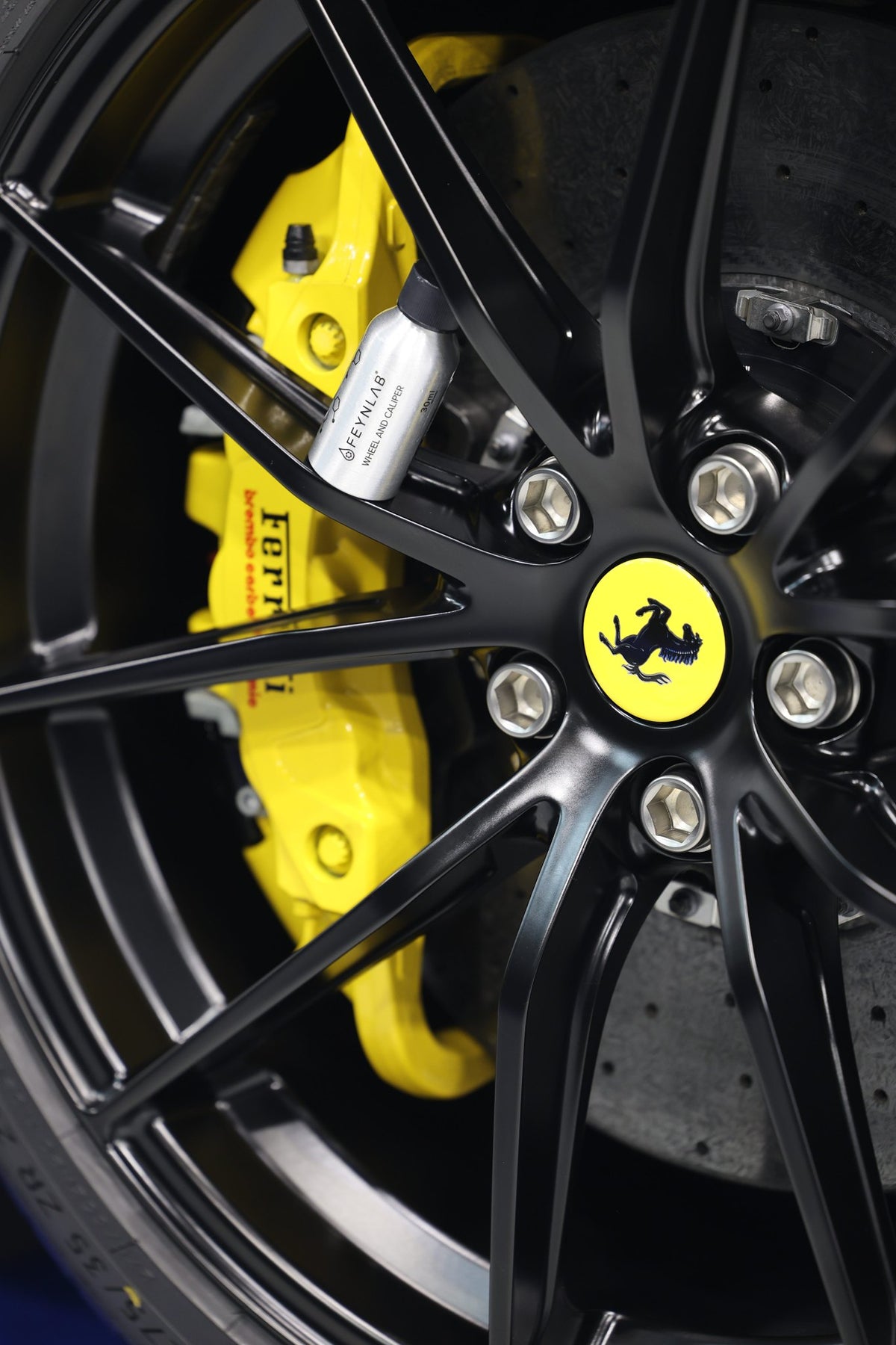 Decontaminated Ferrari wheel with yellow caliper after iron removal at the Alpha Details studio, Melbourne