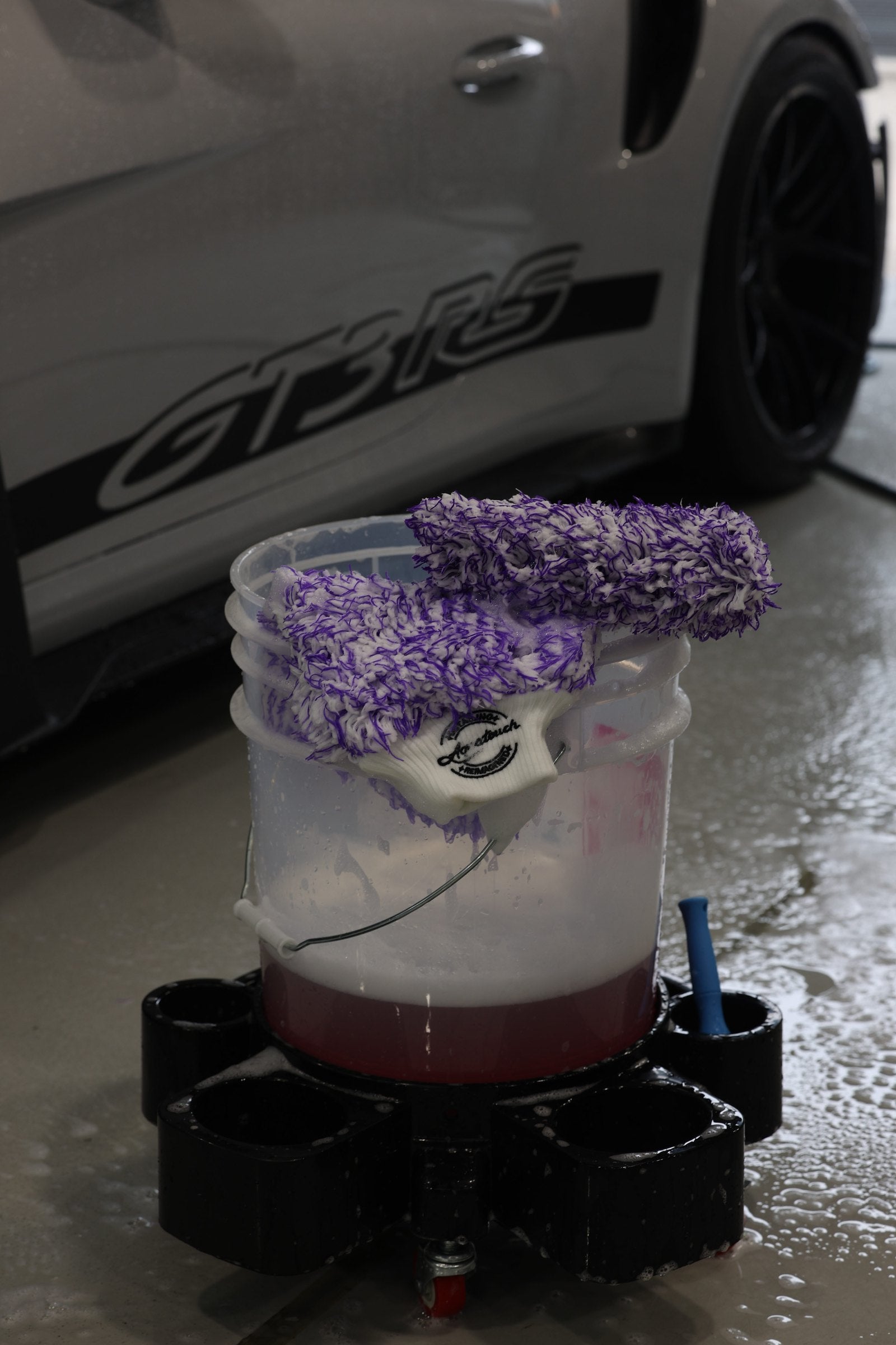 Aquatouch BOSS 600GSM plush microfibre wash mitts on a shampoo bucket beside a Porsche 911 GT3 RS at Alpha Details