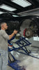 Carton EP.03 cordless electric sprayer in action — applying Maniac Wheel & Tyre Cleaner at 1:5 on a Maserati wheel